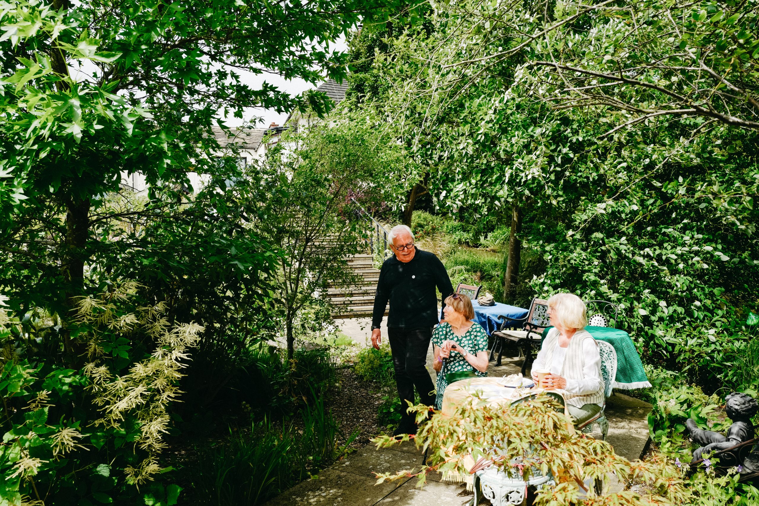 Graham talking to guests in the garden.