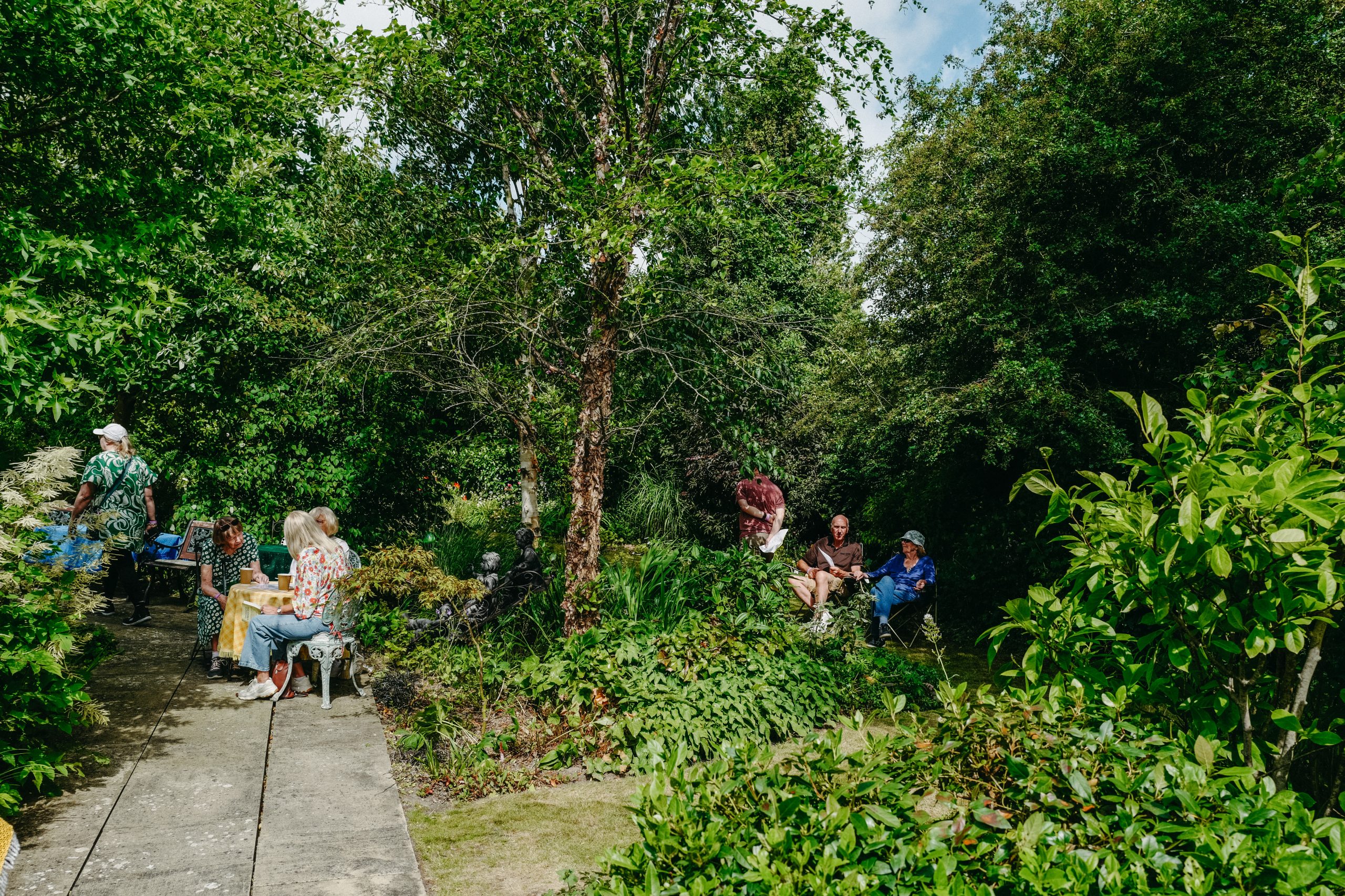 Guests sitting enjoying tea and cake in the garden